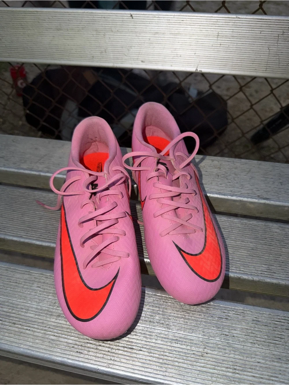 Nike Women’s Pink Soccer Cleats with Orange Swoosh